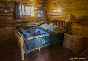Queen bed in one of the Bears Den bedrooms